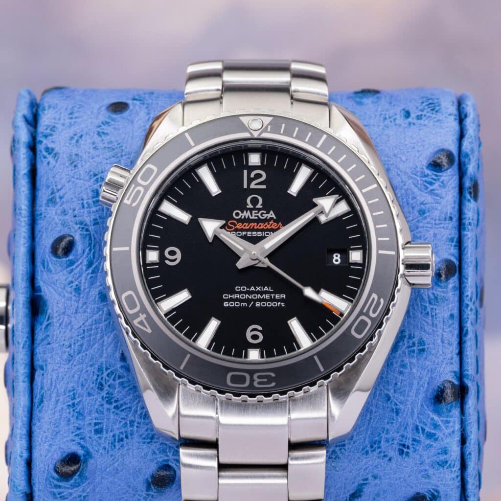 Omega Seamaster Planet Ocean 232.30.42.21.01.001 black dial front view showing orange bezel numerals and steel bracelet