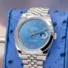 Rolex Datejust 41 azzurro blue dial closeup showing Roman numeral hour markers Chromalight hands and date window at 3 o'clock