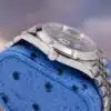 Rolex Datejust 41 126300 crown and case side view on blue ostrich pillow showing Rolex Twinlock winding crown and Jubilee bracelet