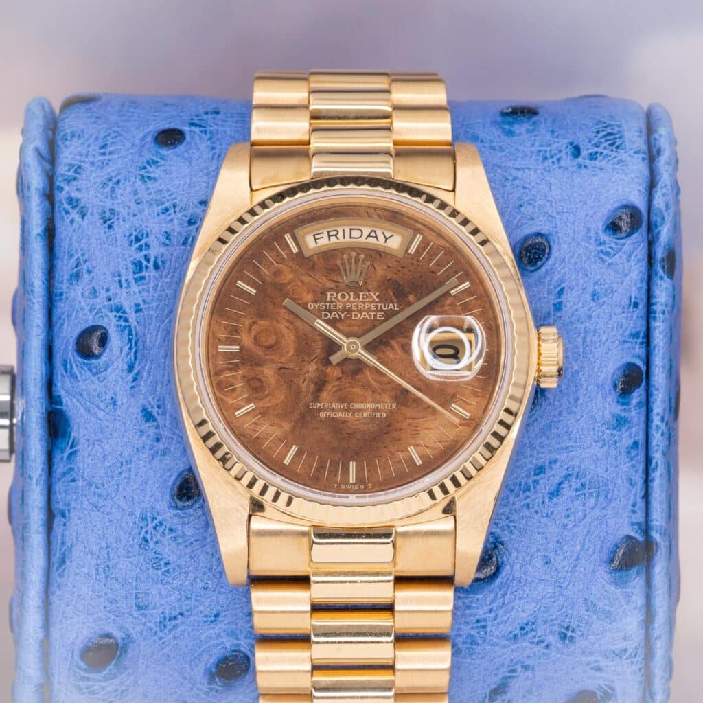 Rolex Day-Date 36 18038 walnut burl wood dial front view on blue ostrich leather pillow showing day-date complication and fluted bezel